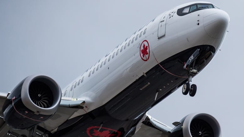 A closeup shows the nose of a plane with an Air Canada logo.