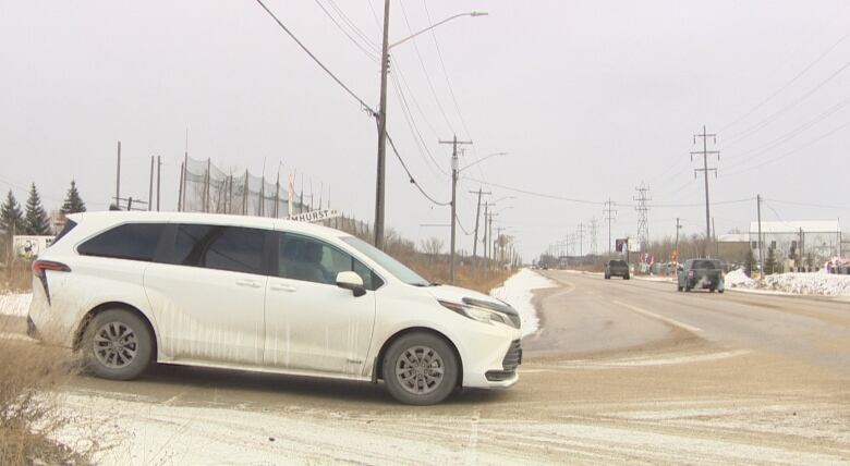 A white van attempts to cross traffic.