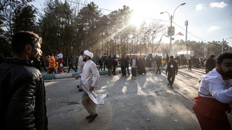 People gather at the scene of an explosion.