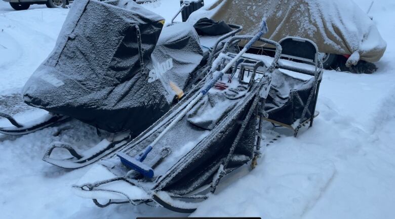 A dog sled under a light layer of frost and snow. 