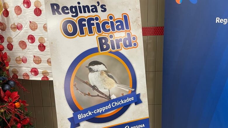 A sign has a photo of a chickadee on it