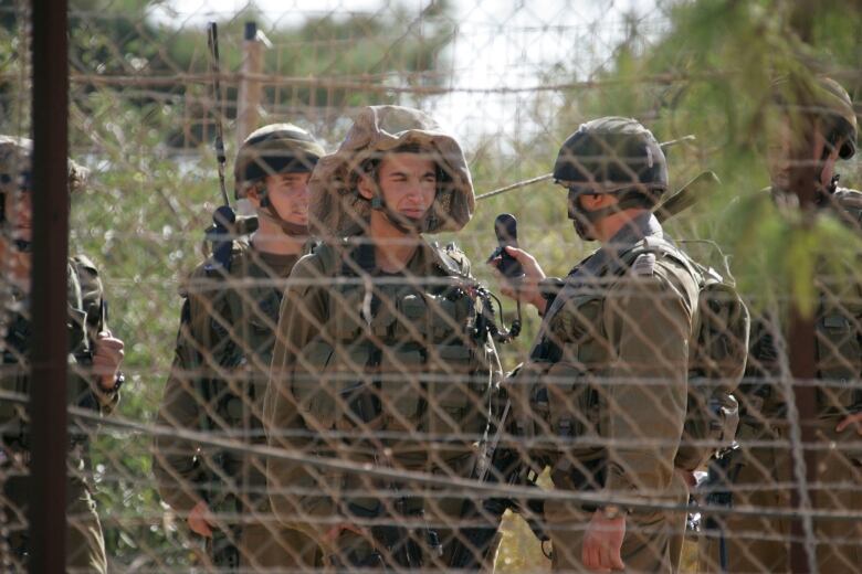 Israeli soldiers patrol the border with Lebanon near Kfarkila village in south Lebanon October 28, 2009. Lebanese army soldiers found and deactivated four rockets on Wednesday in the area from where a rocket had been fired towards northern Israel, witnesses said.  