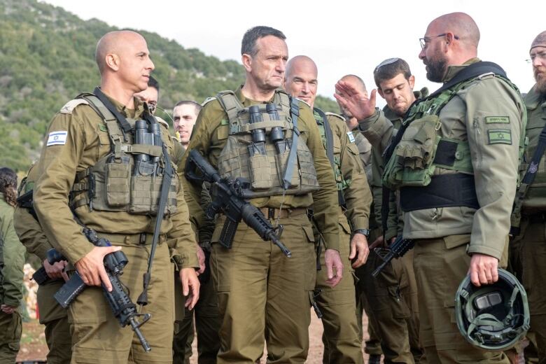 Israeli military Chief of General Staff Herzi Halevi stands with Israeli military soldiers, at a location given as northern Israel, in this picture released on January 3, 2024.   