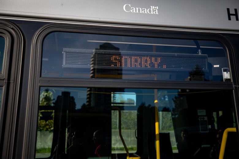 A bus chyron reads 'Sorry'.