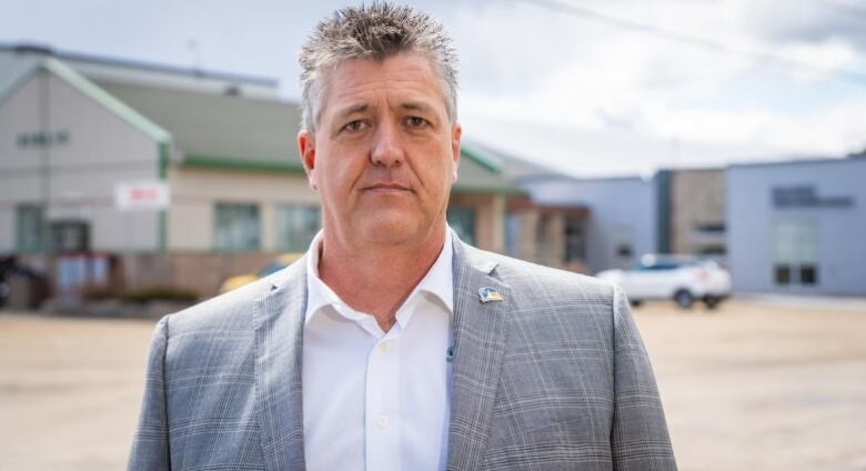 A mayor poses for a photo outside in a warmer month.