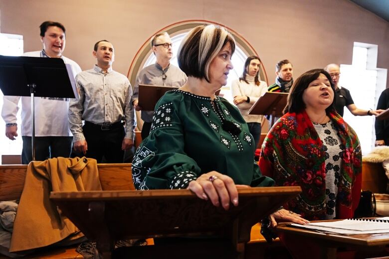 A choir sings inside a church.