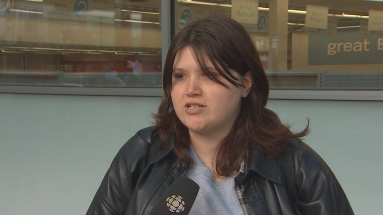 A young woman talks to the camera.