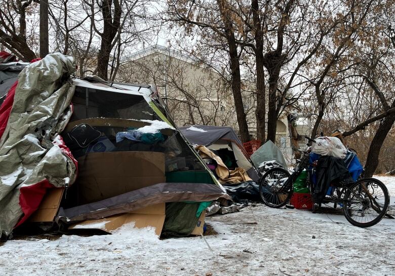 A cluster of tents and tarps in the snow