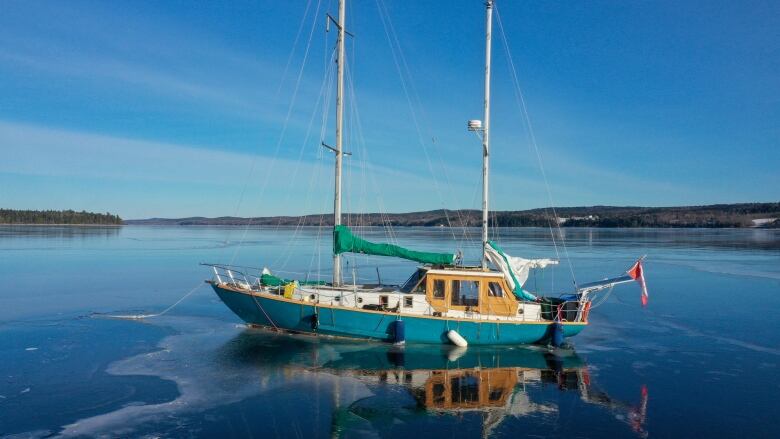 A double-masted sailboat is frozen into the ice on a body of water.  Sailboat frozen into the ice on the St. John River near Browns Flat on Jan. 9, 2024.