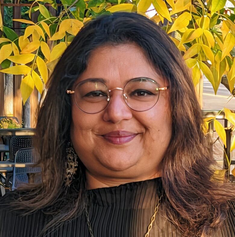 Close-up shot of a smiling woman in black.