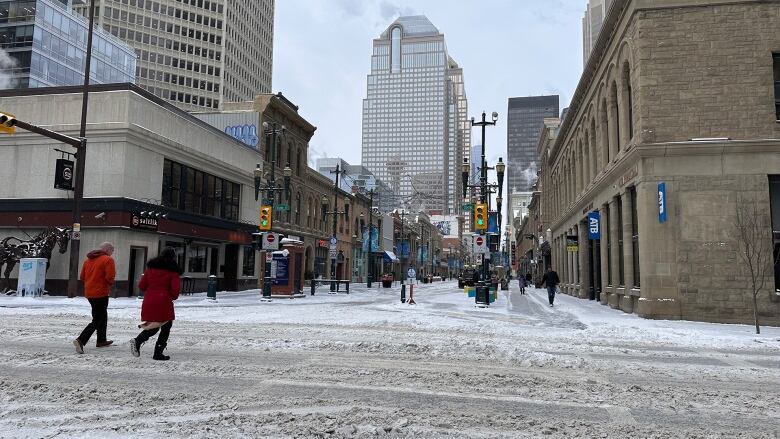 People walk across an intersection. 