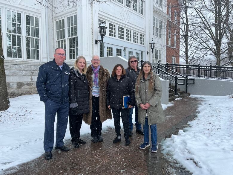 A group of people look into the camera for a photo.