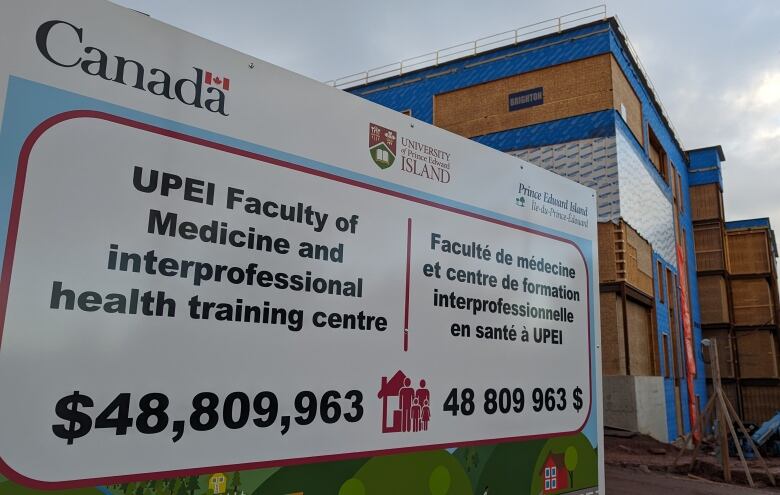 A building under construction is shown in the background with a sign reading UPEI Faculty of Medicine interprofessional health training centre in the foreground.