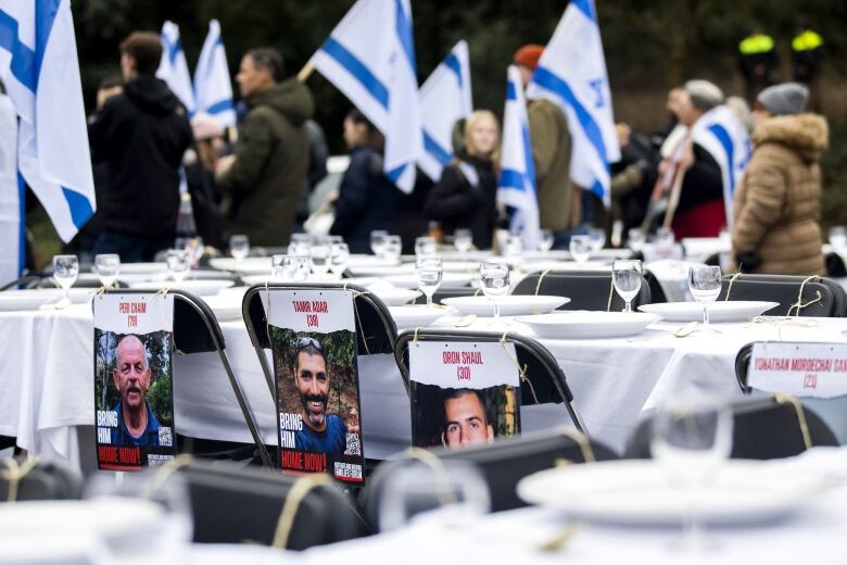 Table settings with glasses and chairs and flags are shown.