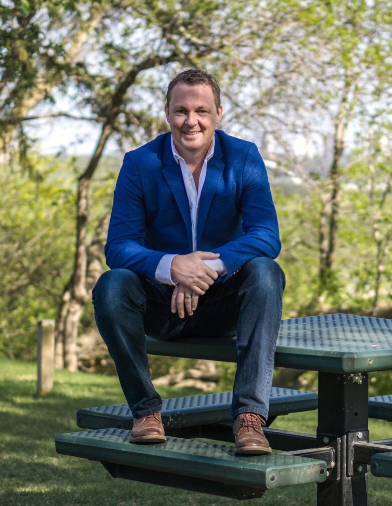 A man sits on a picnic table.