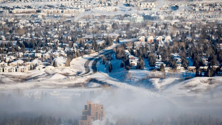 An ice fog hangs over a city.