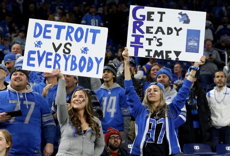 Fans hold signs