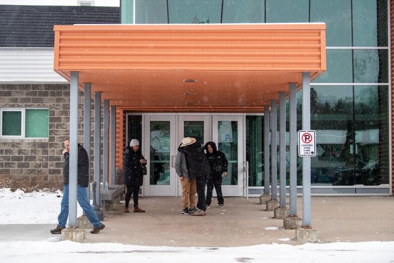 two people hug outside building