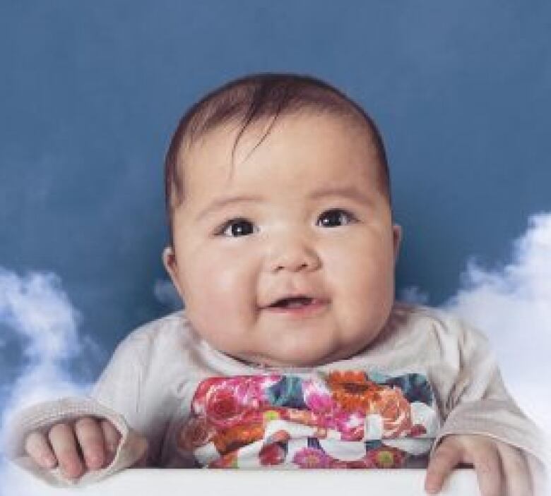 Portrait of a young baby smiling.