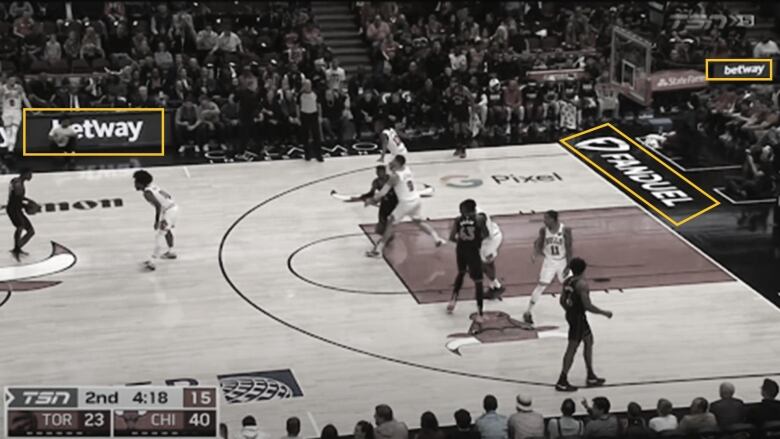 A screenshot of a Raptors vs Chicago Bills broadcast where three gambling company logos are digitally imprinted on the court. 