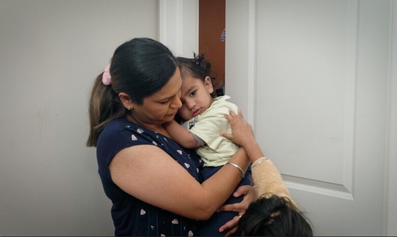 Mom holding a toddler