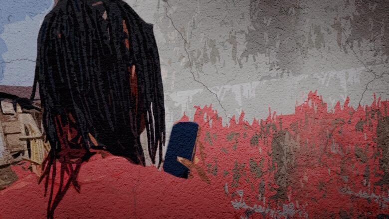 A Black man with thin dreadlocks and a red shirt is standing with the back of his head to the camera. He's looking at a phone in his right hand that has a black screen. 