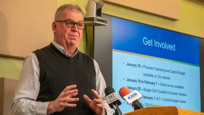 A man speaks at a podium.