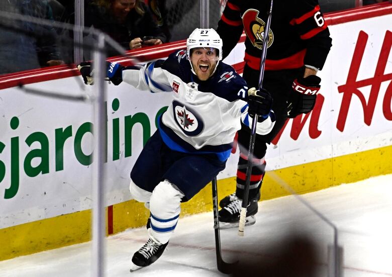 Hockey player celebrates scoring a goal.