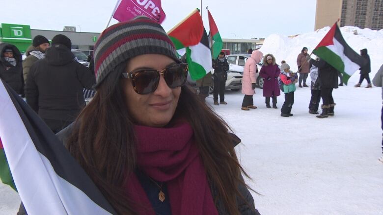 A woman shows support with a flag.