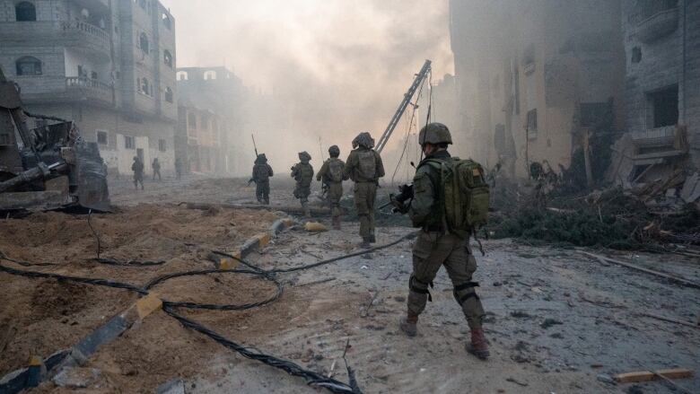 Israeli soldiers walk in the Gaza Strip.