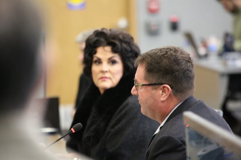 Debi Croucher, executive director of the downtown Windsor BIA listens as the BIA's board chair Chris MacLeod speaks to city council.