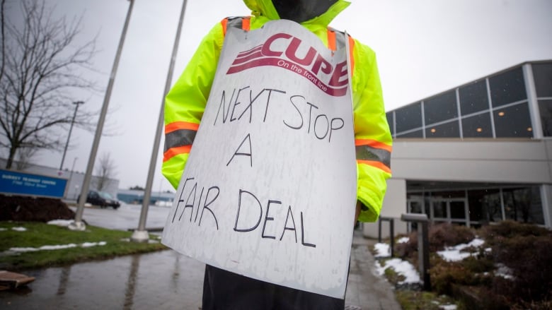 Members of CUPE 4500 are pictured at a picket line in Surrey, British Columbia on Monday, January 22, 2024. 