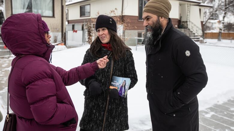 NDP Leader Jagmeet Singh and NDP candidate for Edmonton Centre Trisha Estabrooks meet with a supporter on the street while kicking off the NDP caucus retreat by knocking on doors in Edmonton, Alta. on Monday, January 22, 2024.