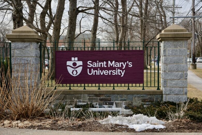 A maroon sign between stone pillars says 'Saint Mary's University.'