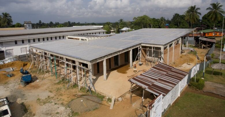 A low-rise building under construction with scaffolding around it. 