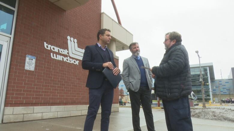 Councillors Fabio Costante and Kieran McKenzie stand outside the Transit Windsor bus terminal downtown.