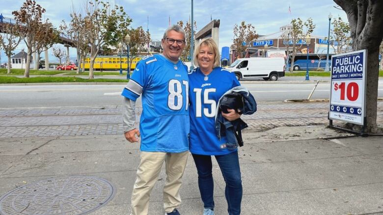 Two people in Detroit Lions jerseys