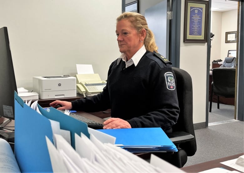 Jennifer McCarron at desk.