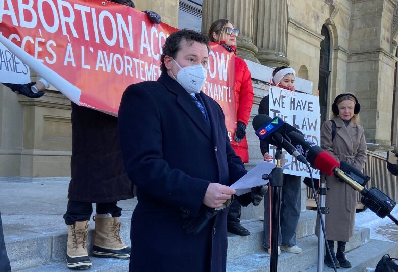 Adrian Edgar address people outside the New Brunswick Legislature.