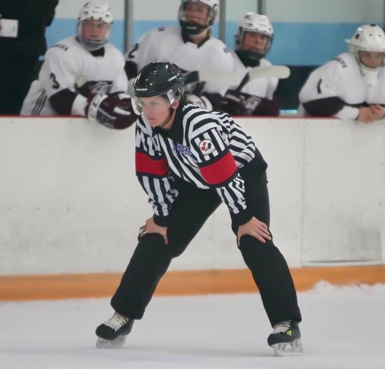 A hockey referee is shown on the ice