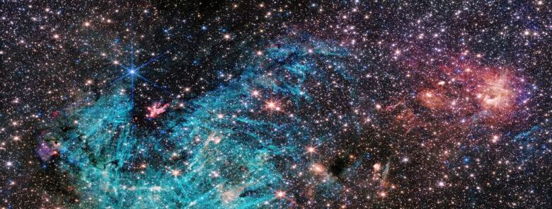 The view from inside the Milky Way galaxy looks crowded with so many stars on a black background in a colourful spectrum, from cyan to magenta.