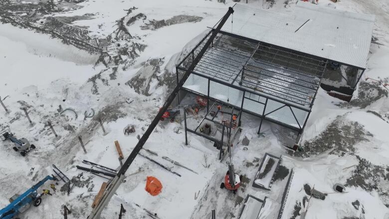 Shot outside of construction for a small steel structure, covered in snow.