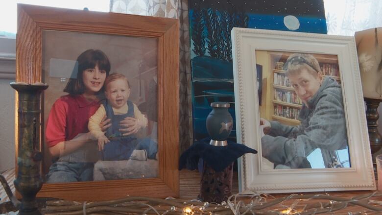 Two framed photos. One of a teenage boy. The other of a little girl holding a baby boy.