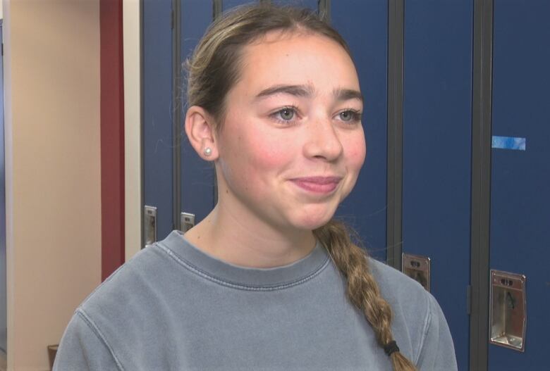 Sofie Arsenault in front of school lockers.