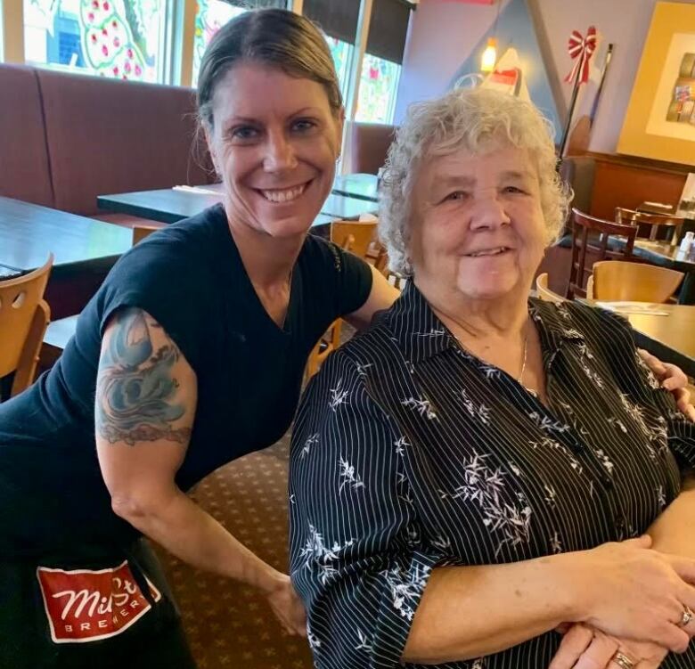 Two women pose for the camera.