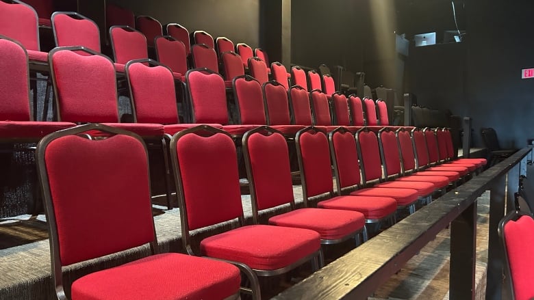 a row of red chairs in the theater at the Guild. 