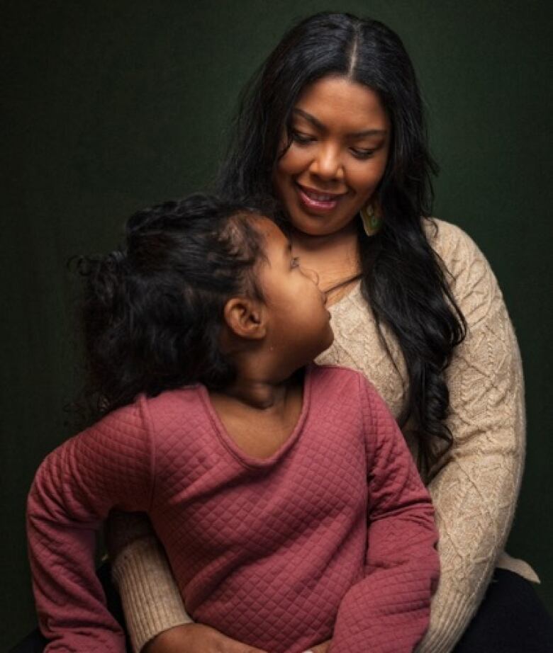 A mother and daughter look loving at each other 