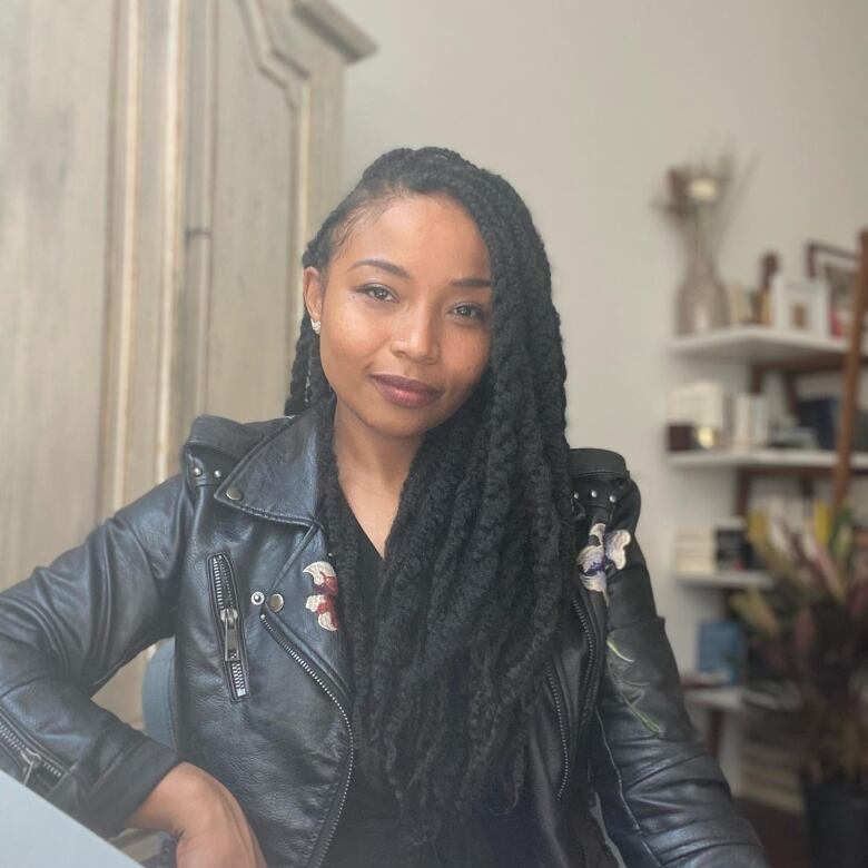 An Afro Indigenous woman in a leather jacket