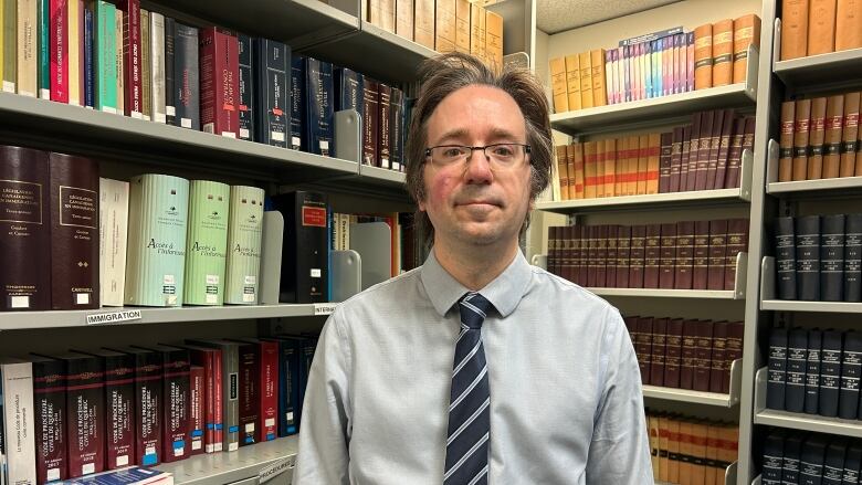 man in front of a bookcase