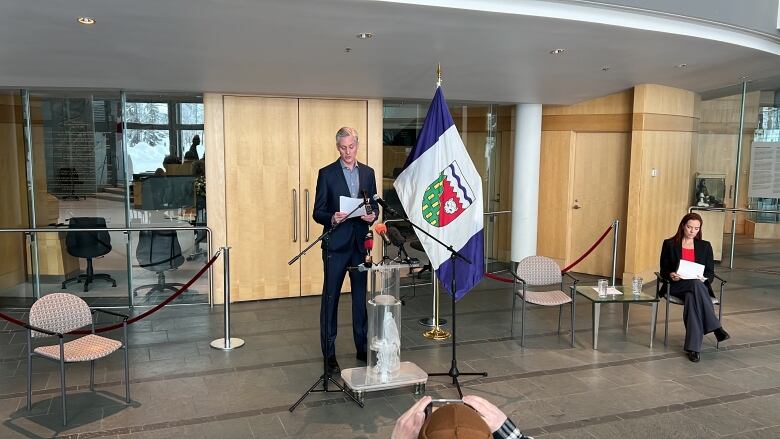 A man stands before a podium. 